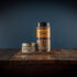 Bourbon Barrel Foods Bourbon Smoked Pepper in a shaker and a tin.